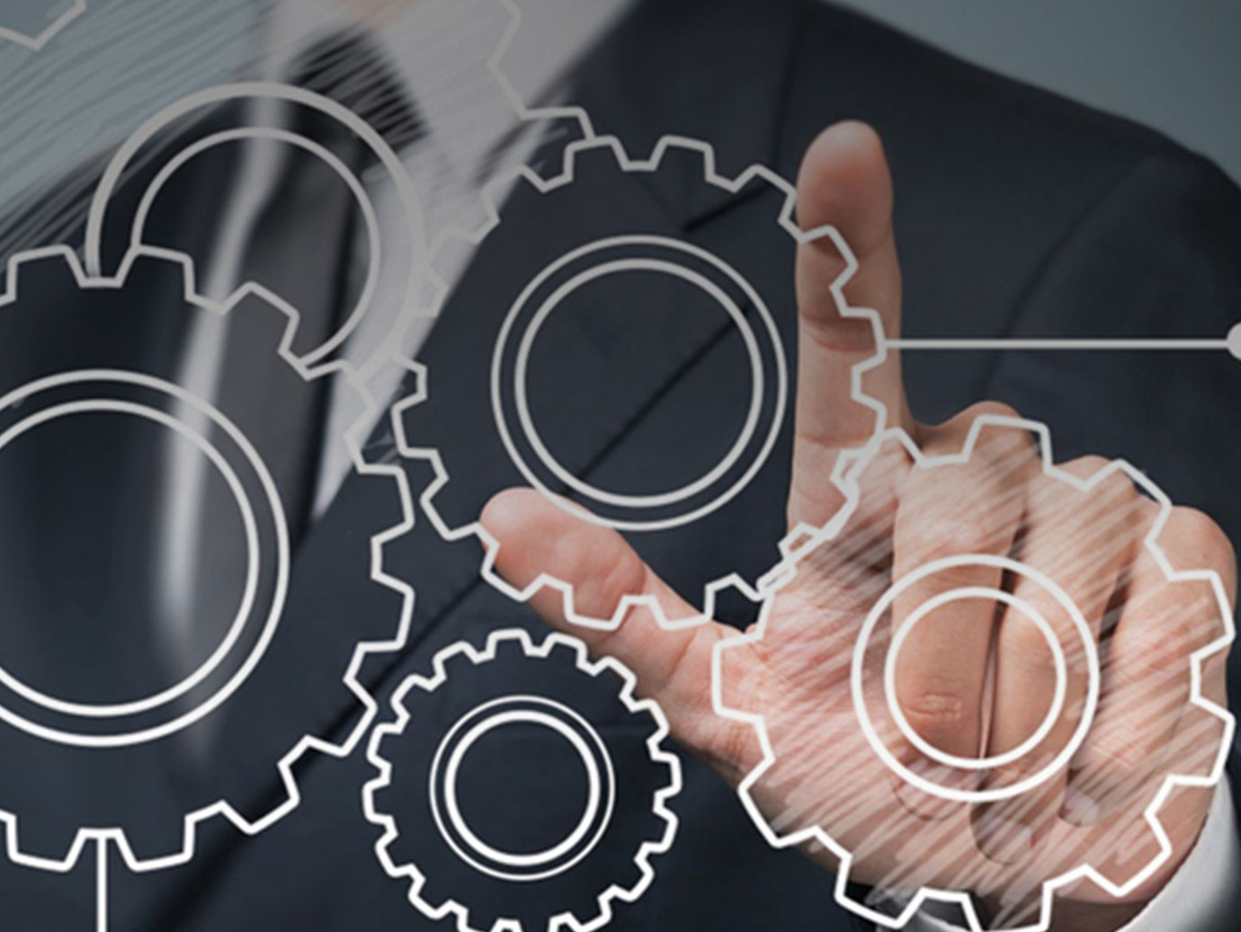 Businessman draws the gears as concept icon on a glass 