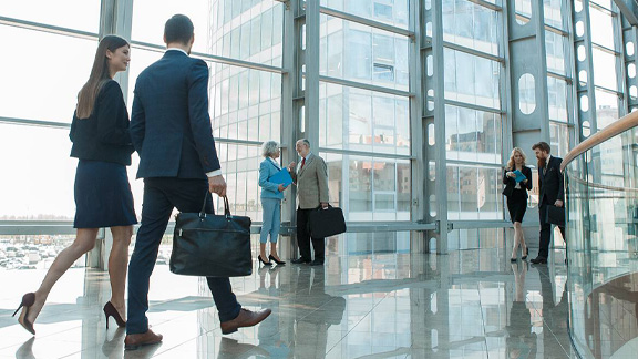 View of employees having the casual discussion and walking in the corridor 