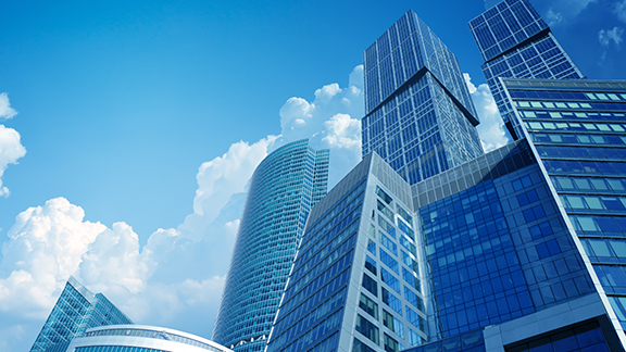 Skyscrapers with blue glass windows against a daytime sky
